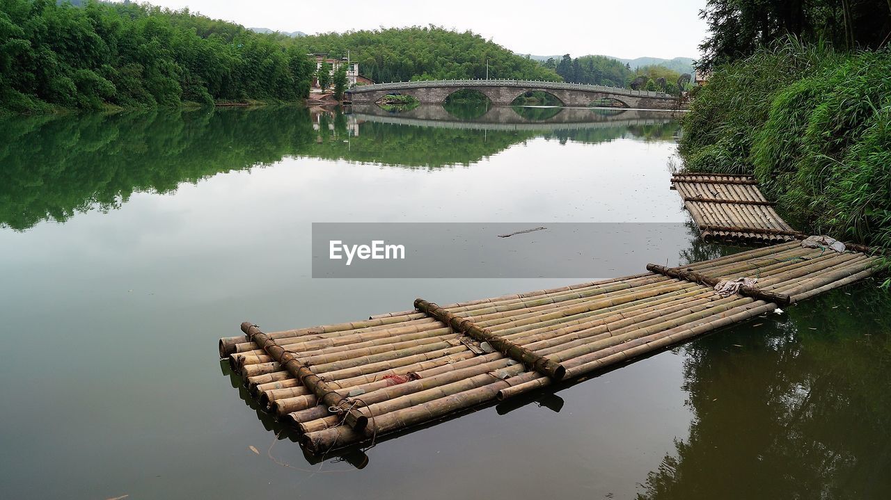 HIGH ANGLE VIEW OF LAKE AND TREES AGAINST SKY