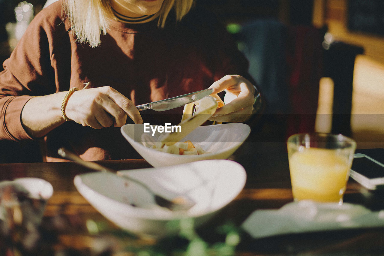 Mid section of woman preparing food