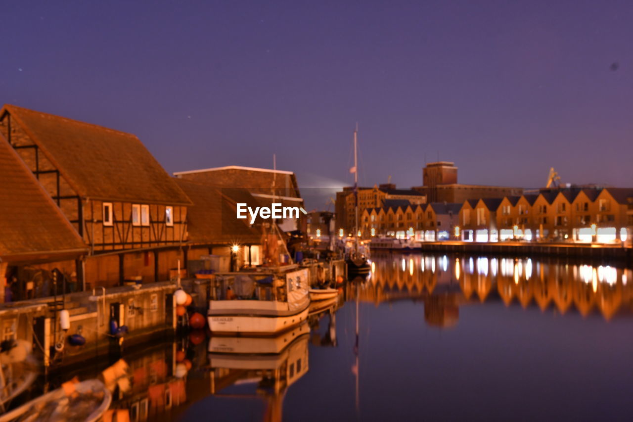 BUILDINGS AT WATERFRONT AT NIGHT