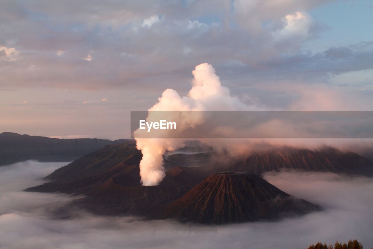 Active volcano at bromo-tengger-semeru national park against cloudy sky