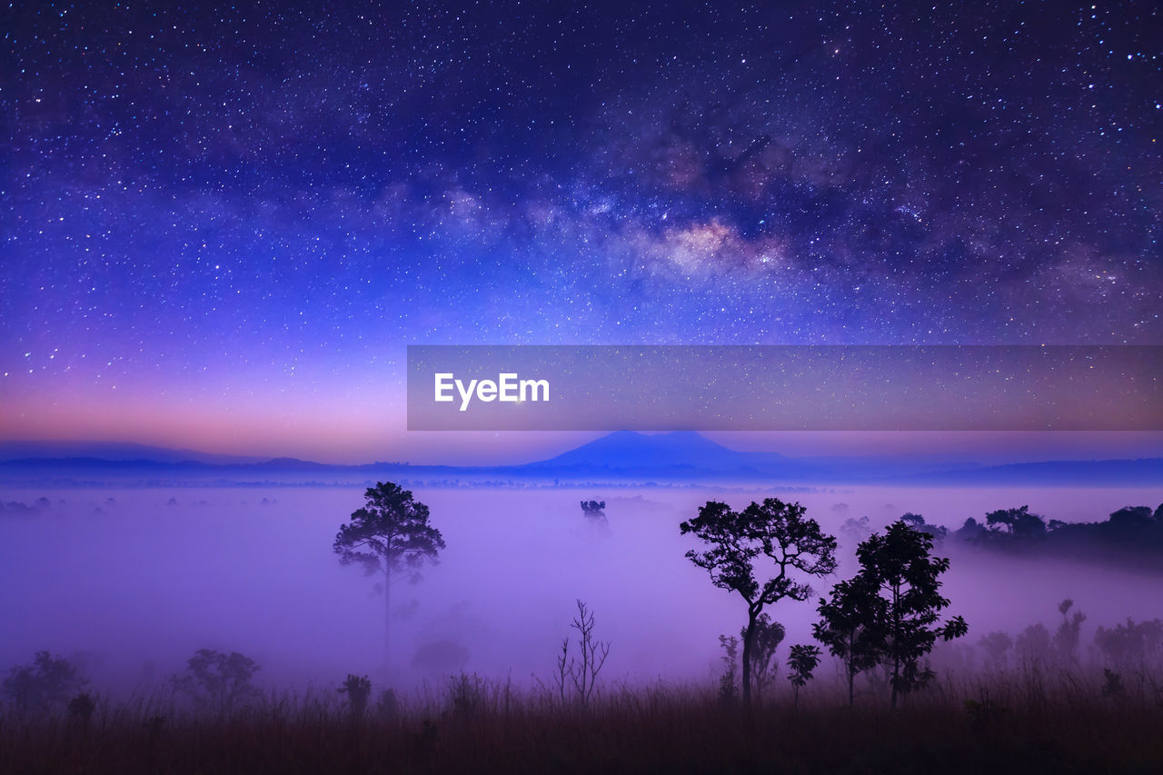 Scenic view of lake against sky at night