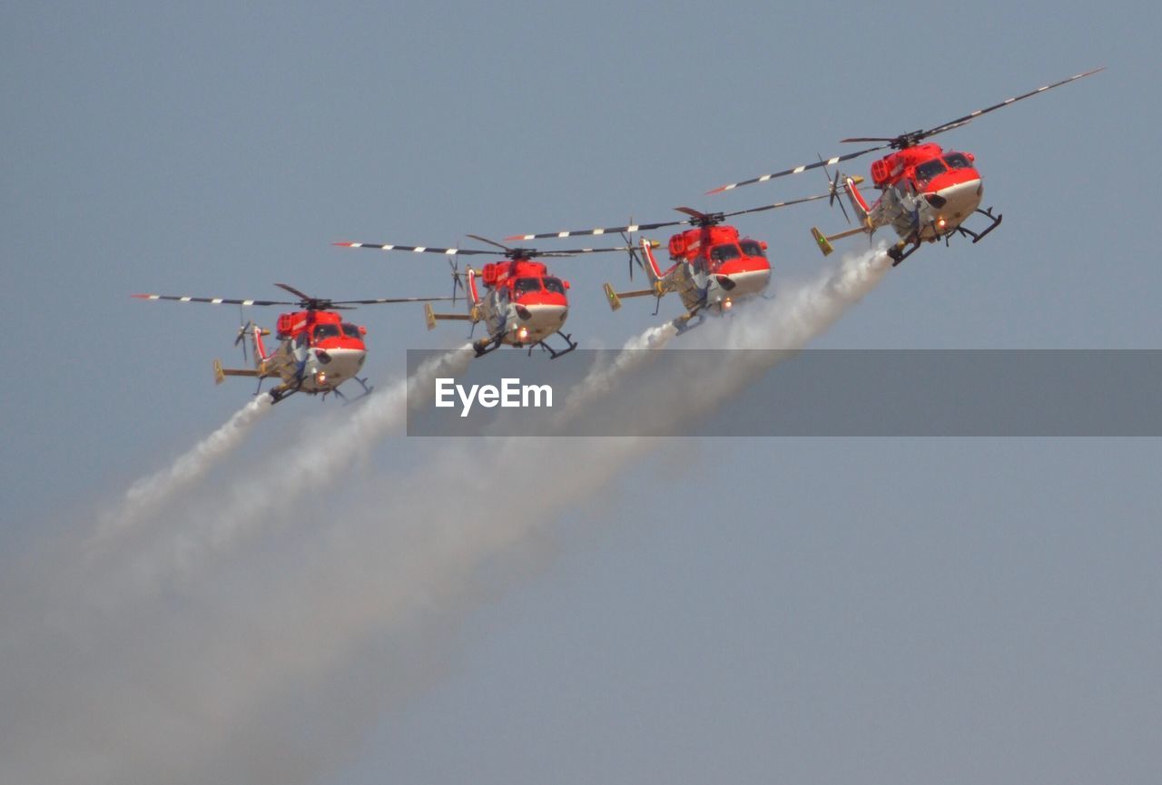 Low angle view of airshow against sky