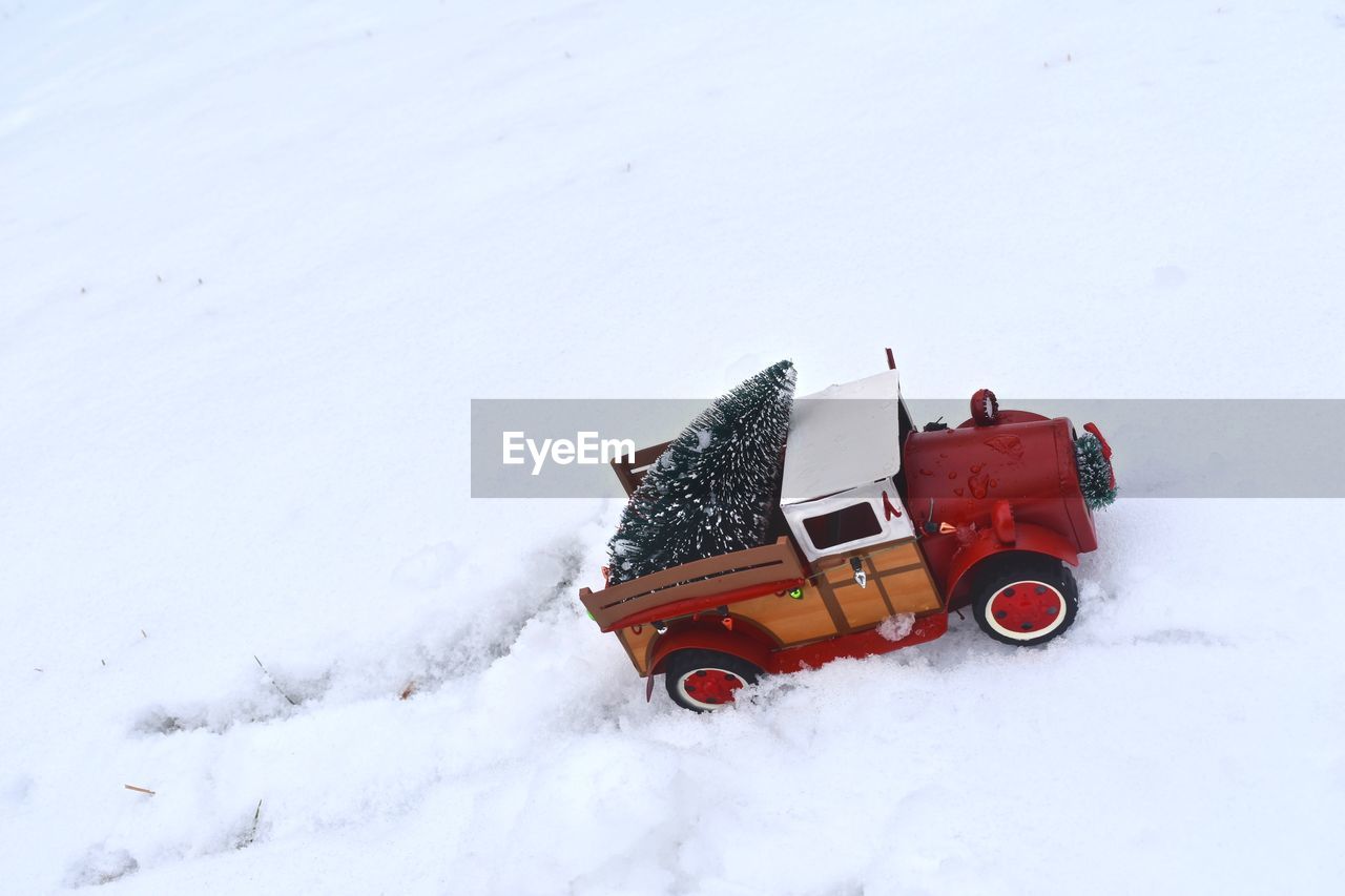 CAR ON SNOW COVERED FIELD