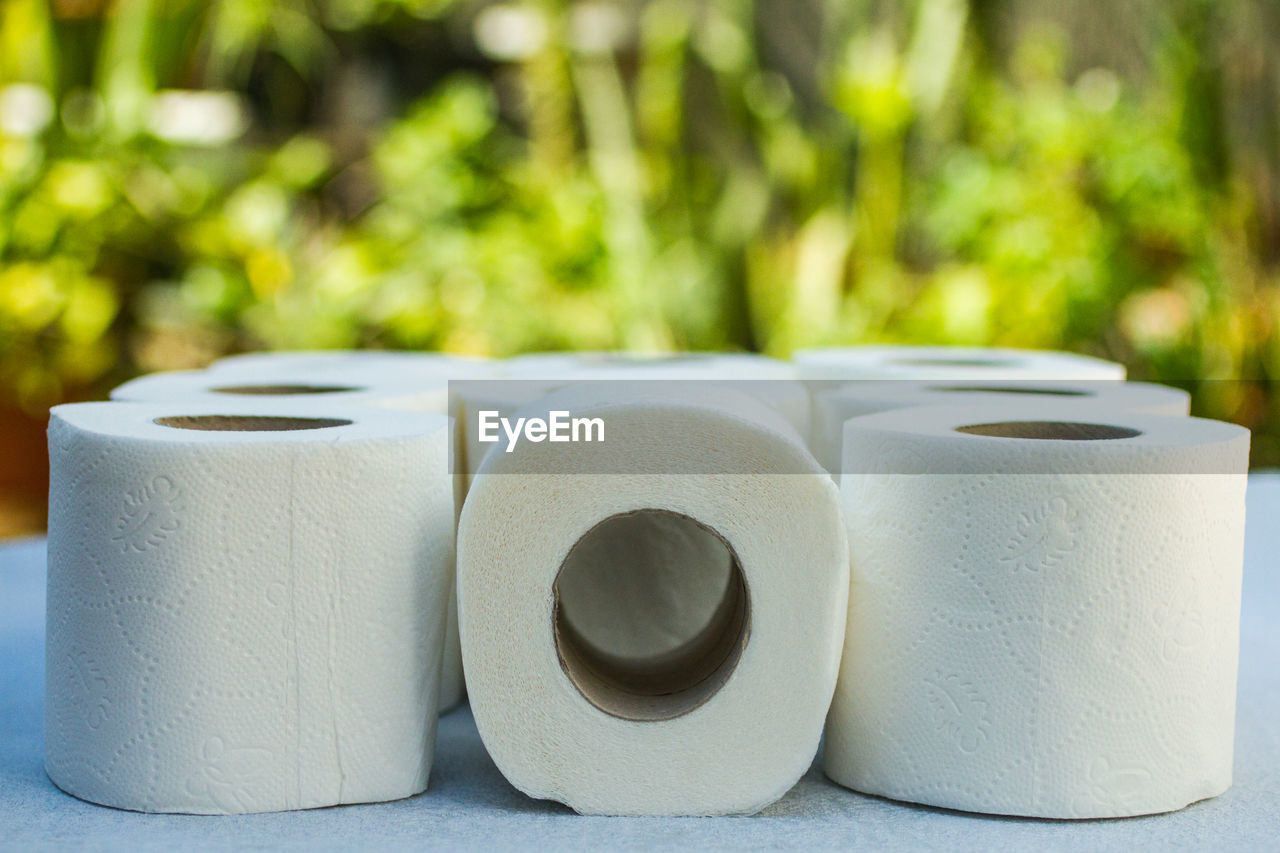 CLOSE-UP OF OBJECTS ON TABLE AGAINST BLURRED BACKGROUND