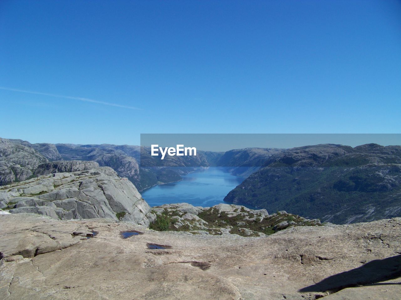 Scenic view of mountains against clear blue sky