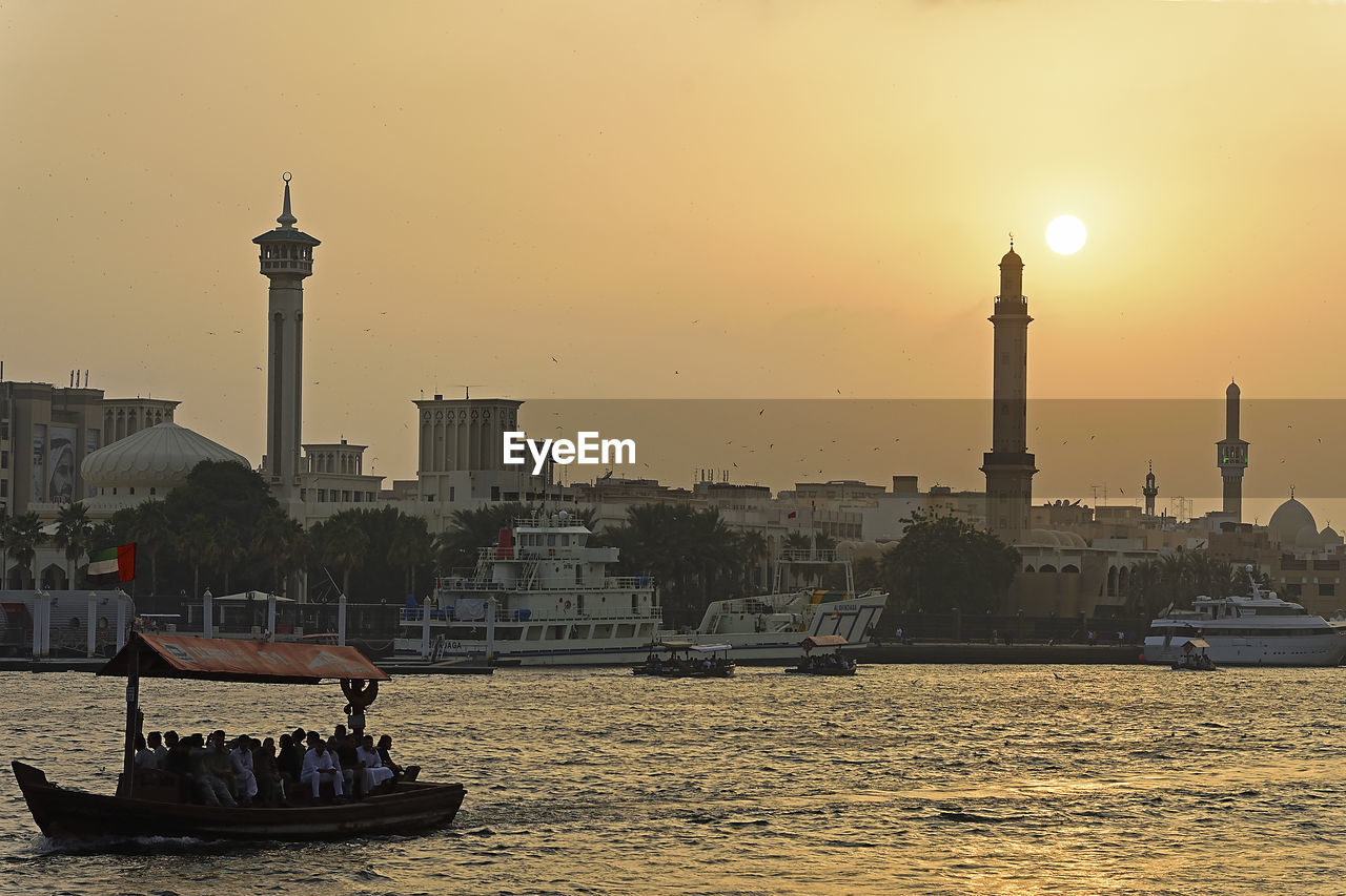 Buildings in city at sunset