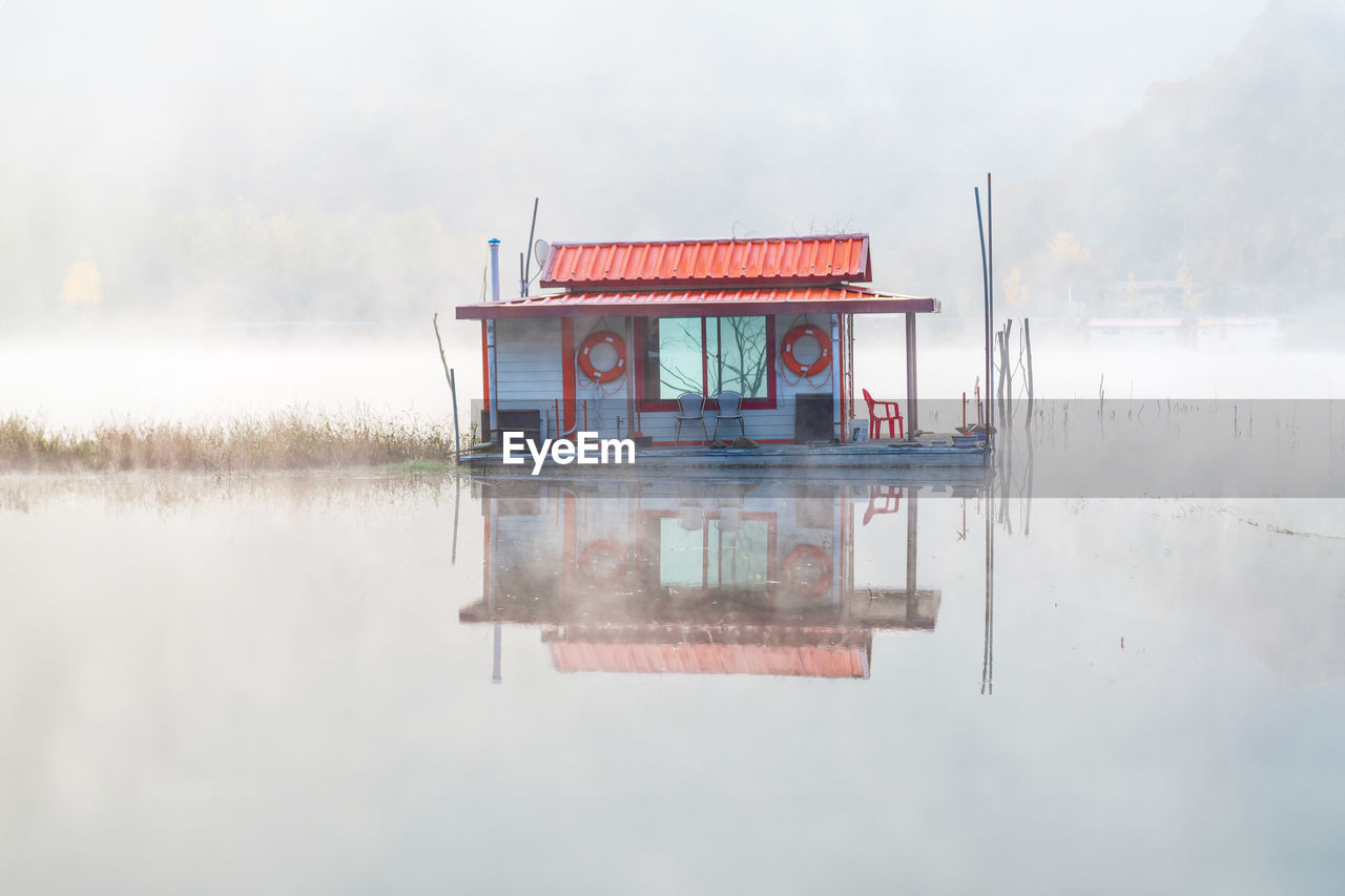 reflection of built structures in lake