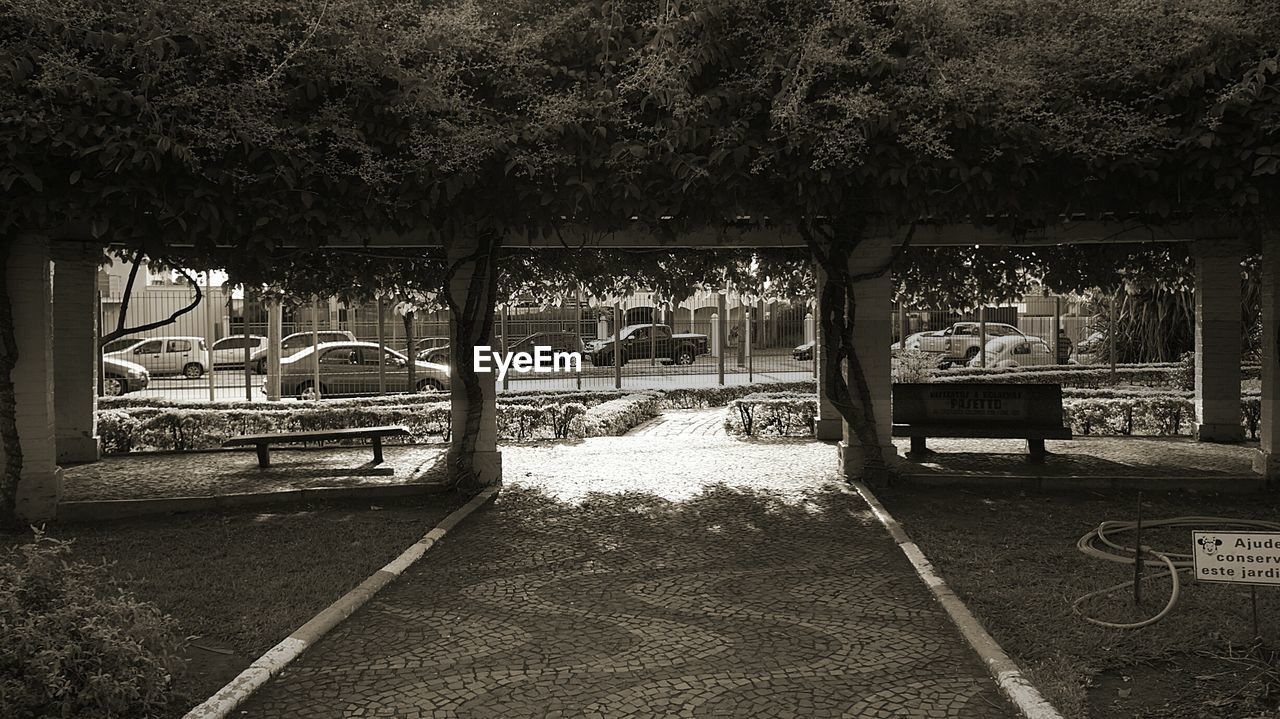 Cars in parking lot seen through footpath