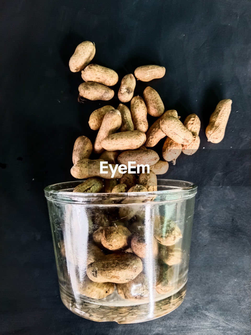 Close-up of peanuts in glass jar on table