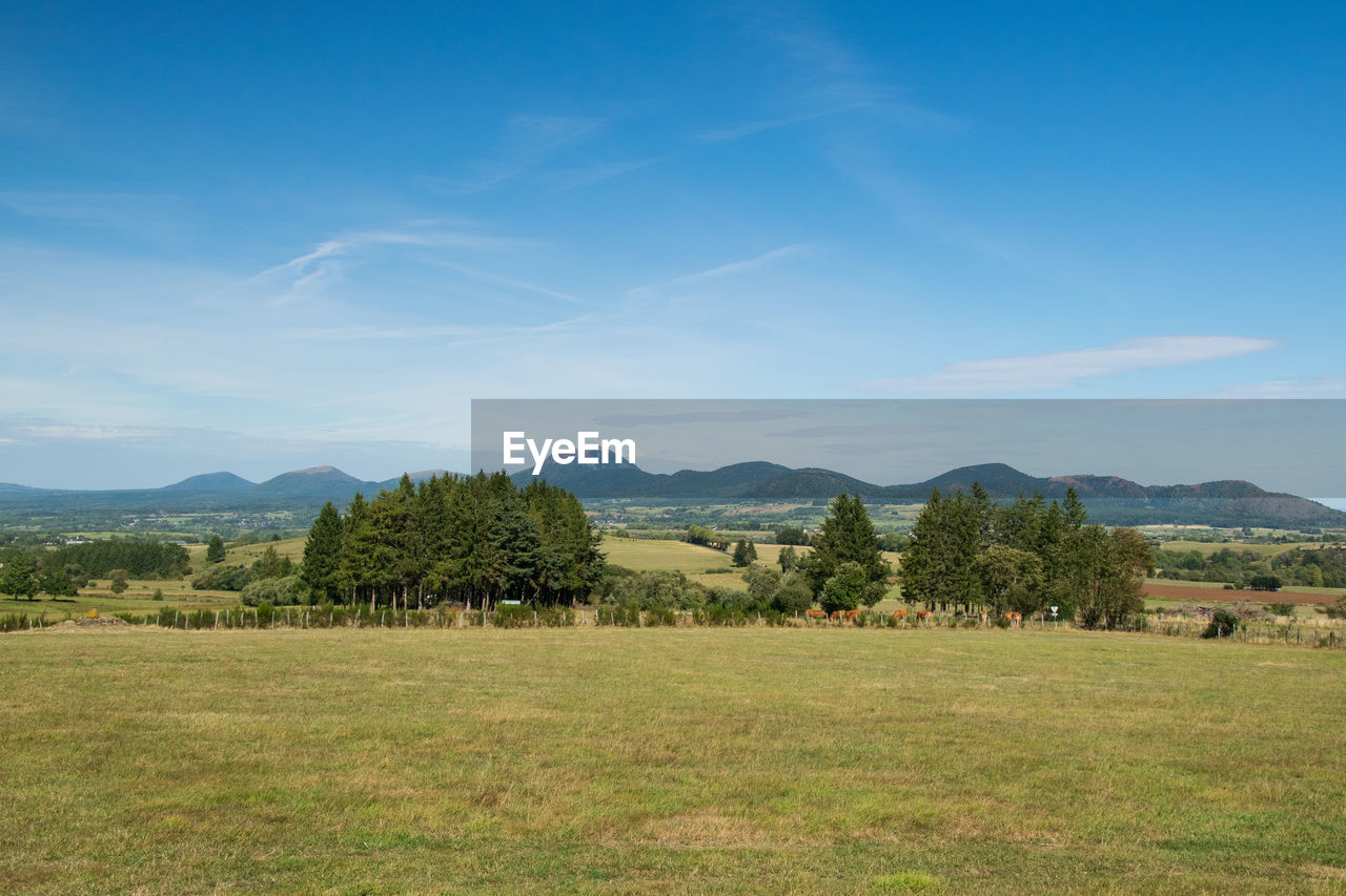 Scenic view  to auvergne volcanos of field against sky