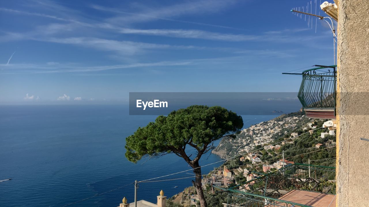 Scenic view of sea by building against sky