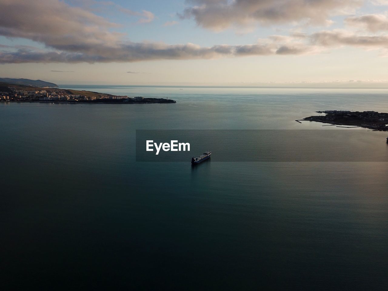 Scenic view of sea and ship against sky