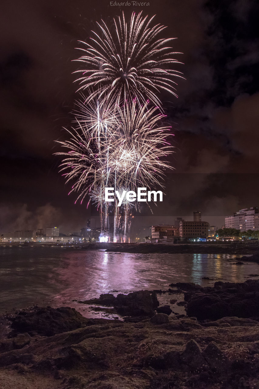 Firework display over city at night