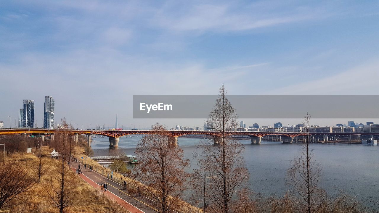 Bridge over river with city in background