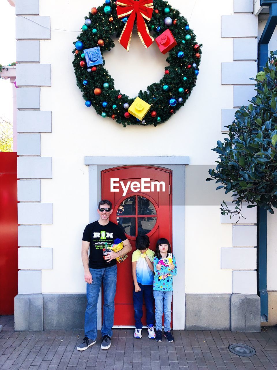 Portrait of family people standing against door