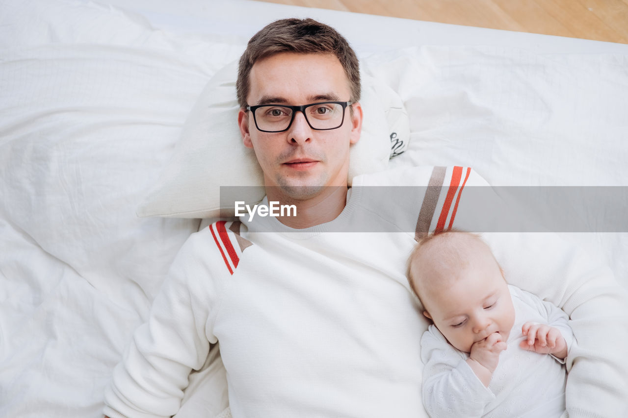 Portrait of cute baby girl sleeping on bed at home