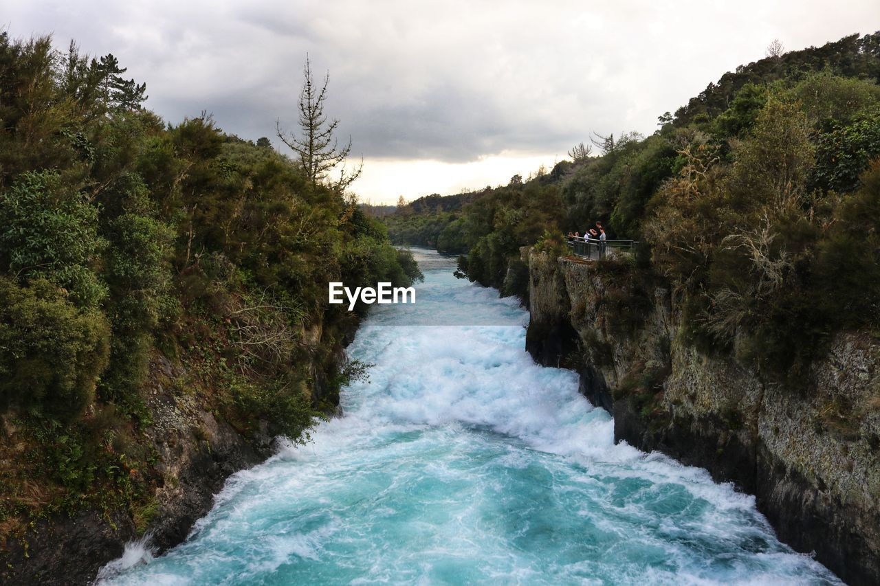 SCENIC VIEW OF WATER FLOWING THROUGH ROCKS