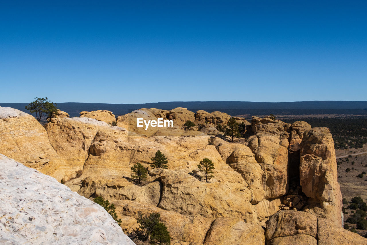 Landscape of massive yellow stone formation overlooking at el morro national monument in new mexico