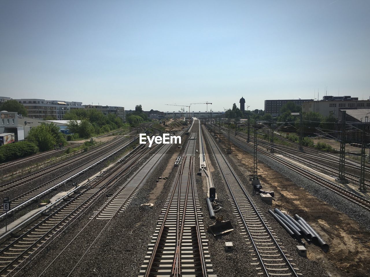 High angle view of empty railroad tracks in city against sky
