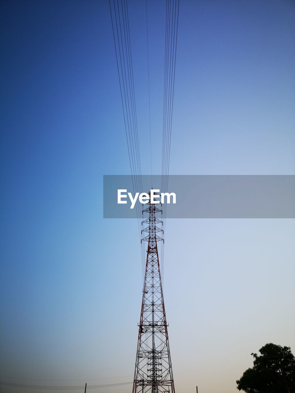 Low angle view of electricity pylon against clear sky