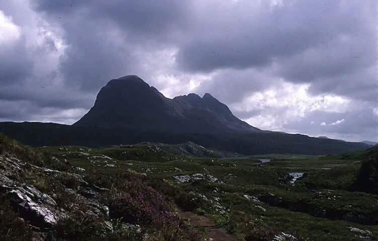 SCENIC VIEW OF MOUNTAINS AGAINST CLOUDY SKY