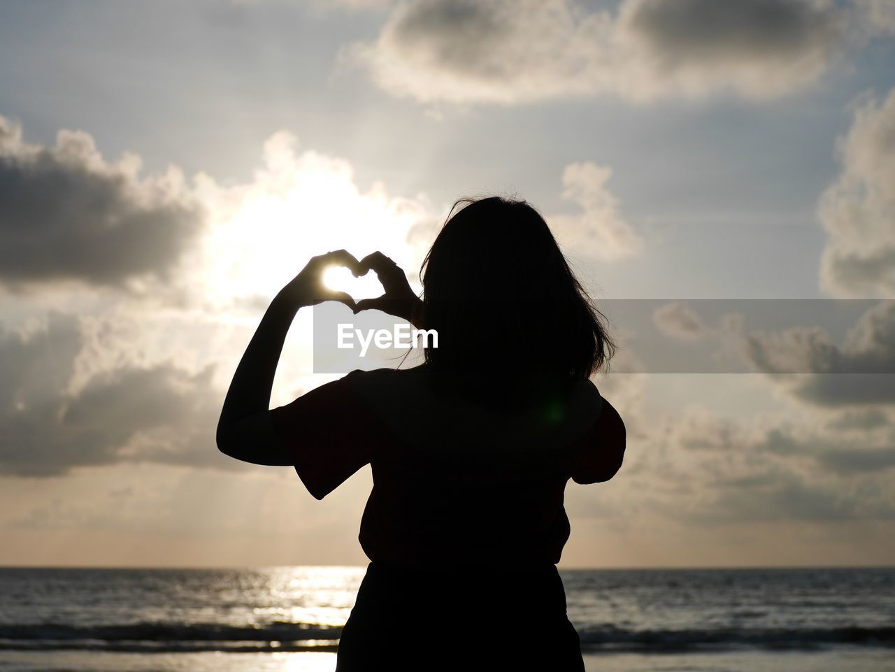 SILHOUETTE WOMAN ON BEACH DURING SUNSET