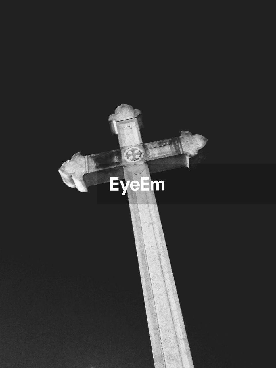 LOW ANGLE VIEW OF CROSS IN THE DARK