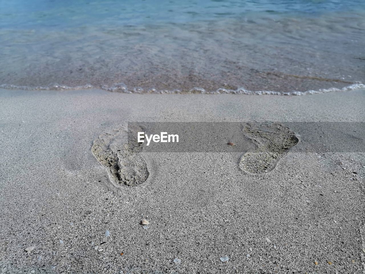 High angle view of footprints on beach