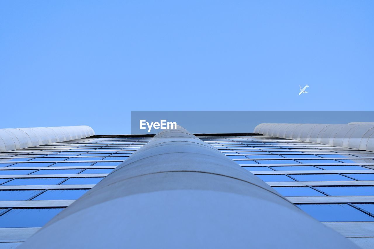LOW ANGLE VIEW OF BUILDING AGAINST BLUE SKY