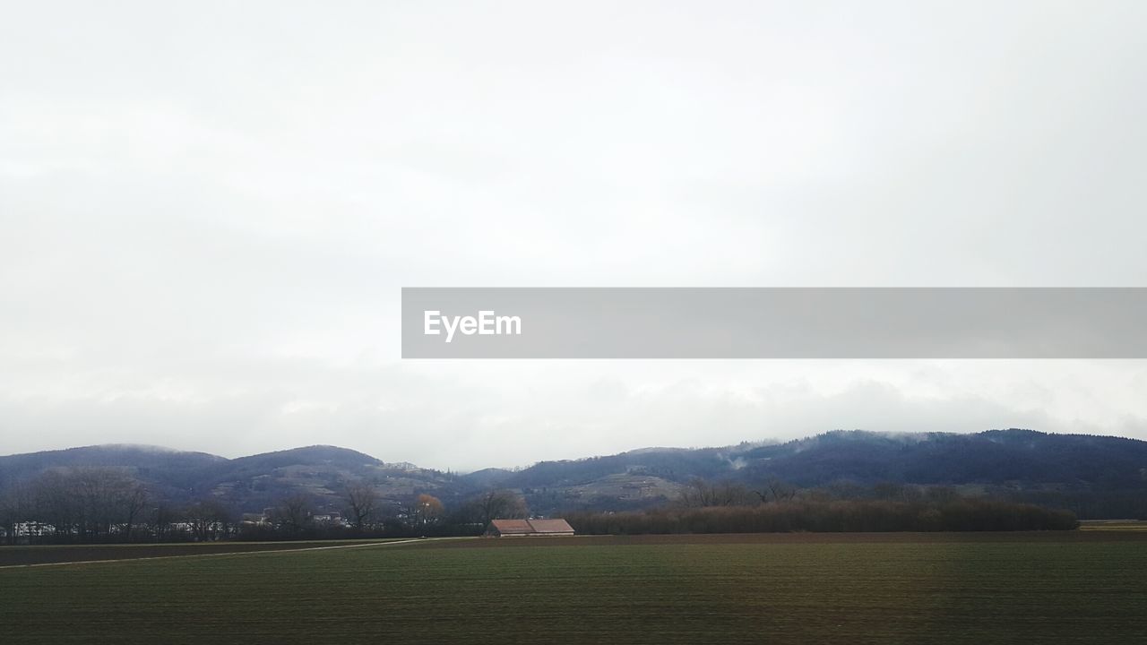 VIEW OF FIELD AGAINST SKY