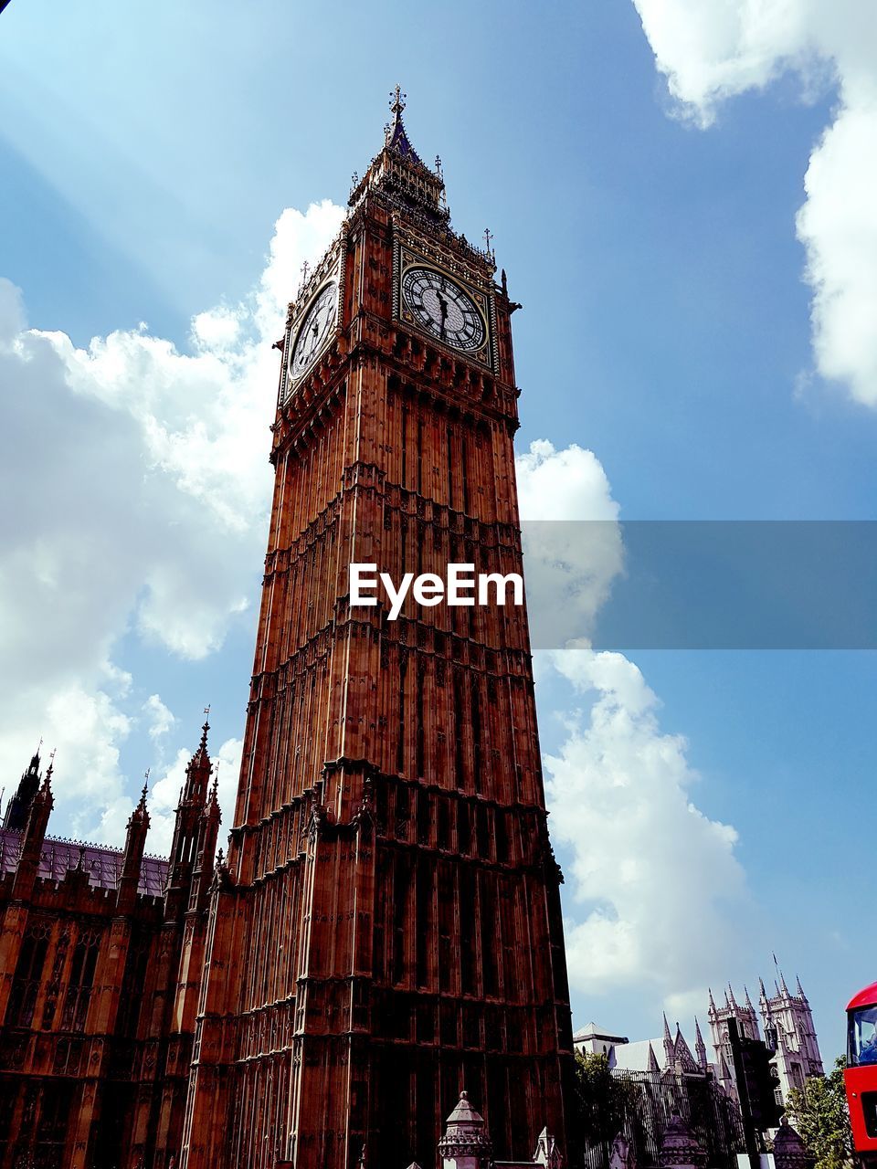 Low angle view of clock tower against blue sky