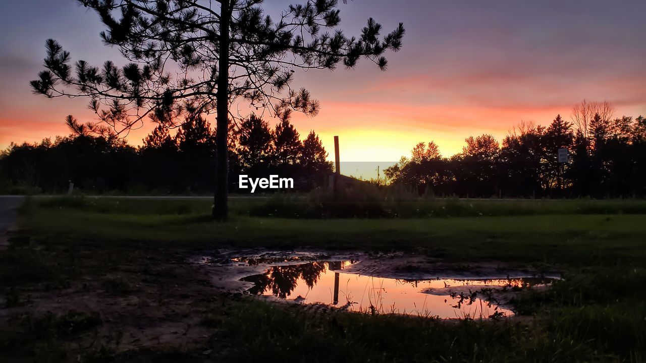 Scenic view of lake against sky during sunset