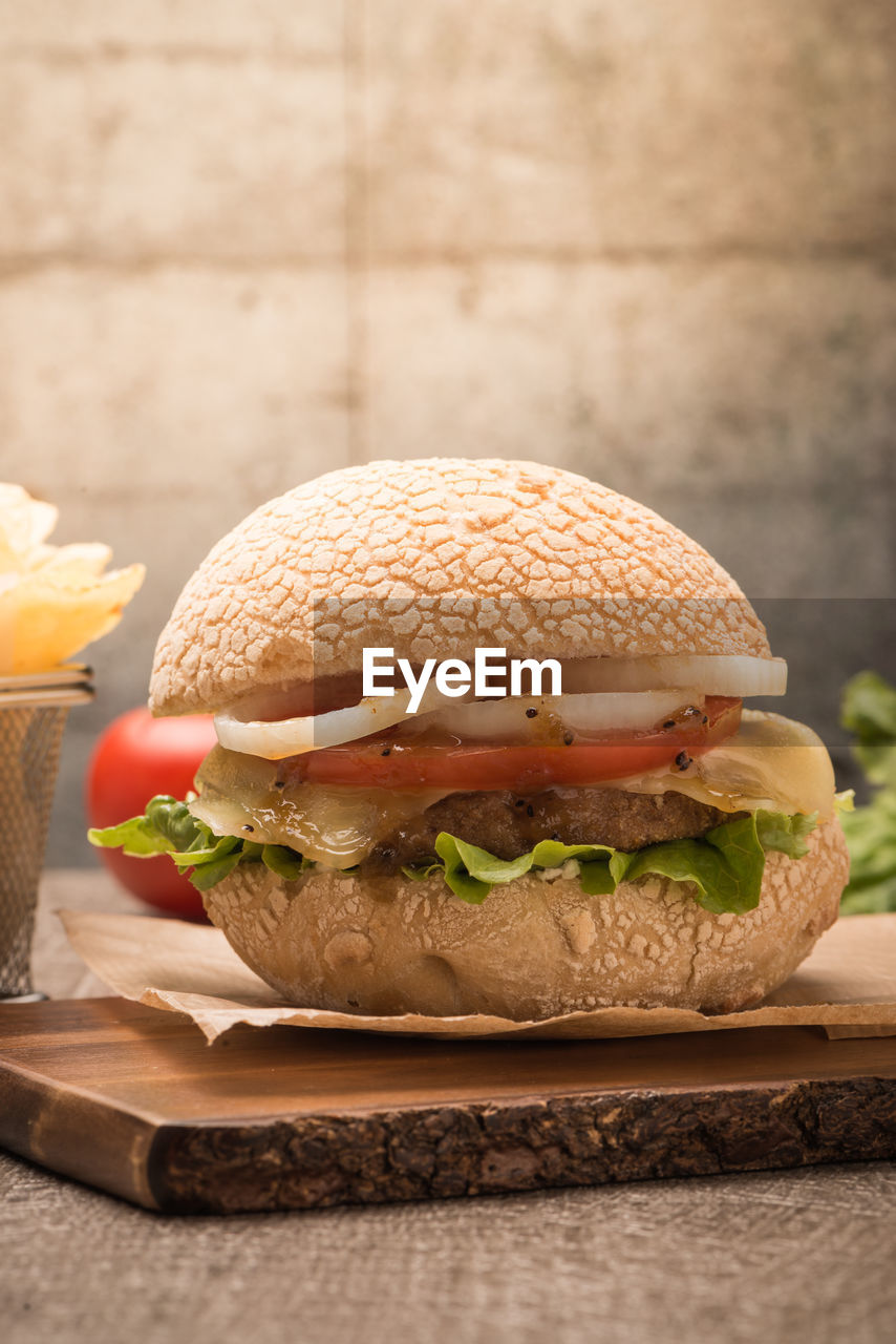 close-up of burger with french fries on table