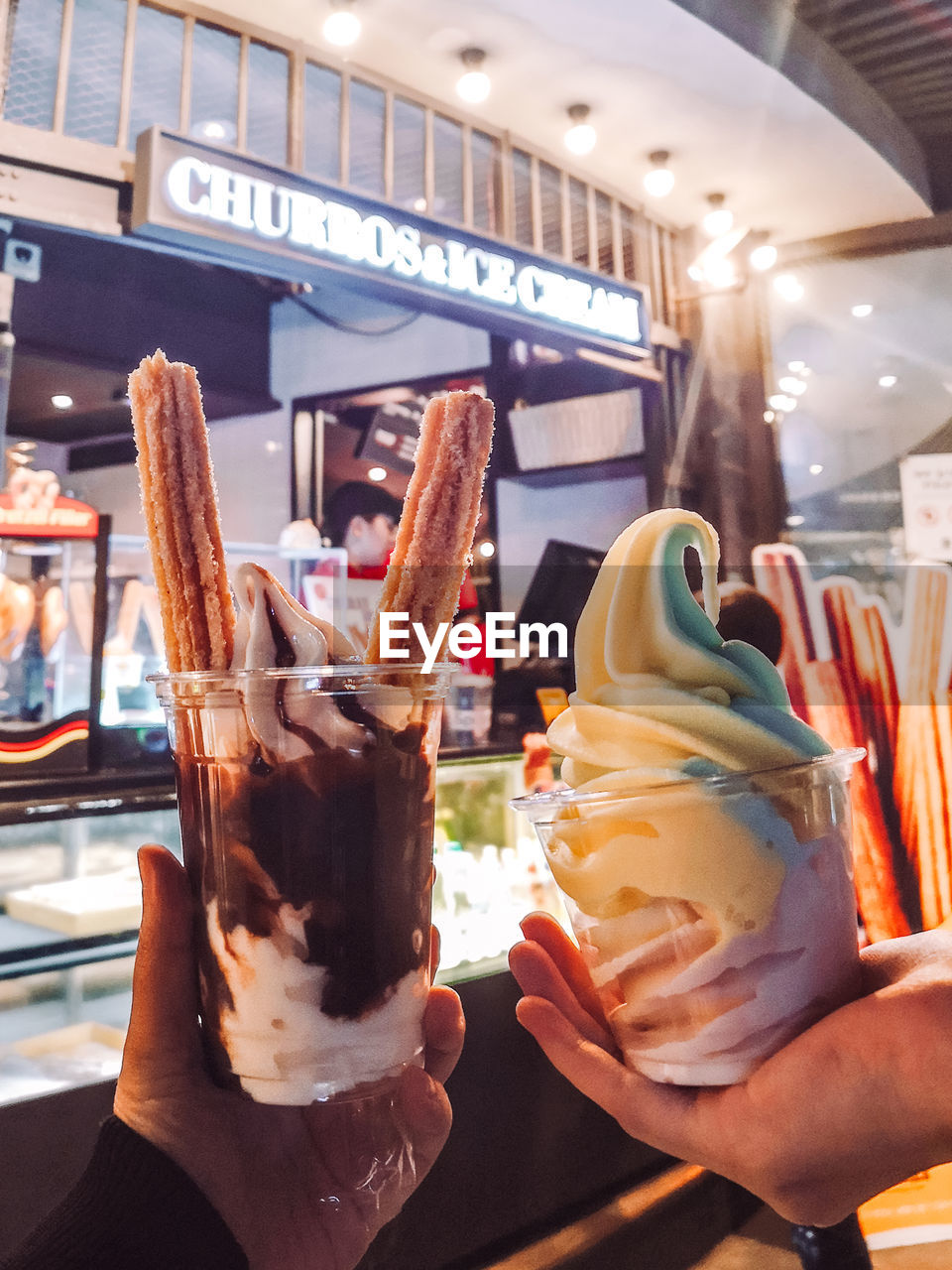 MAN HOLDING ICE CREAM IN GLASS