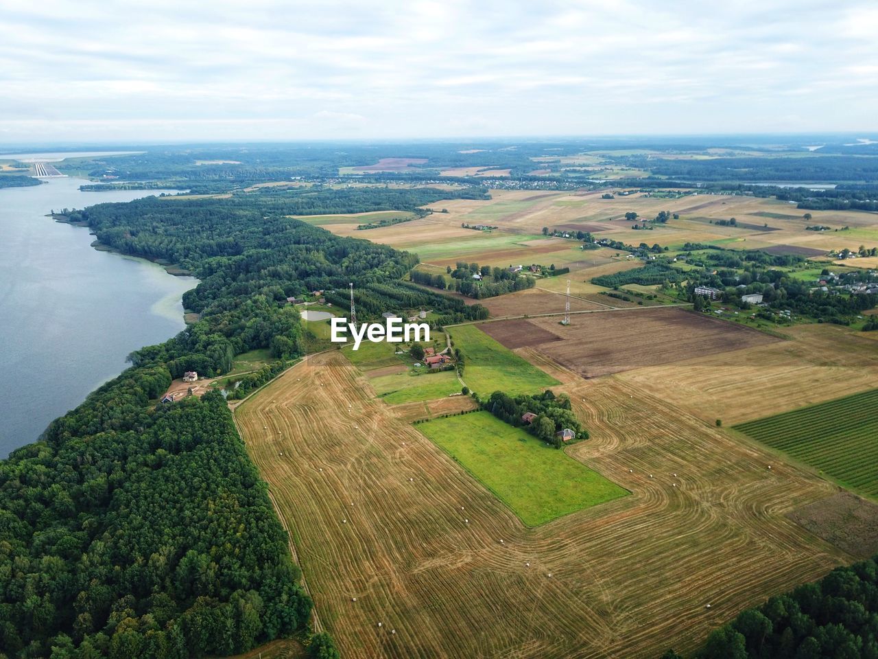 Scenic view of agricultural landscape against sky