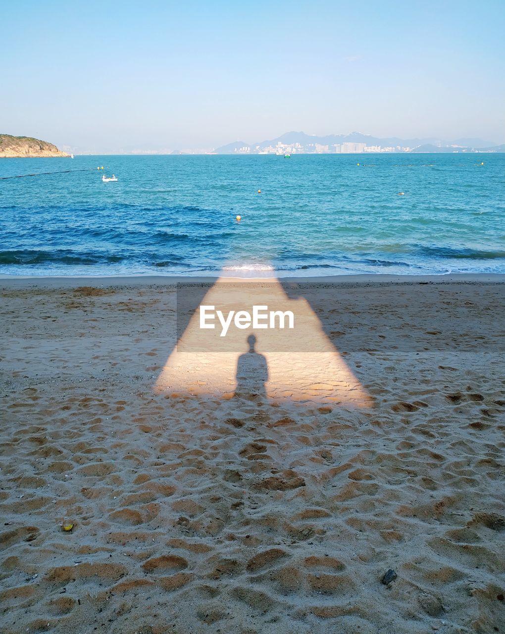 Rear view of man on beach against sky