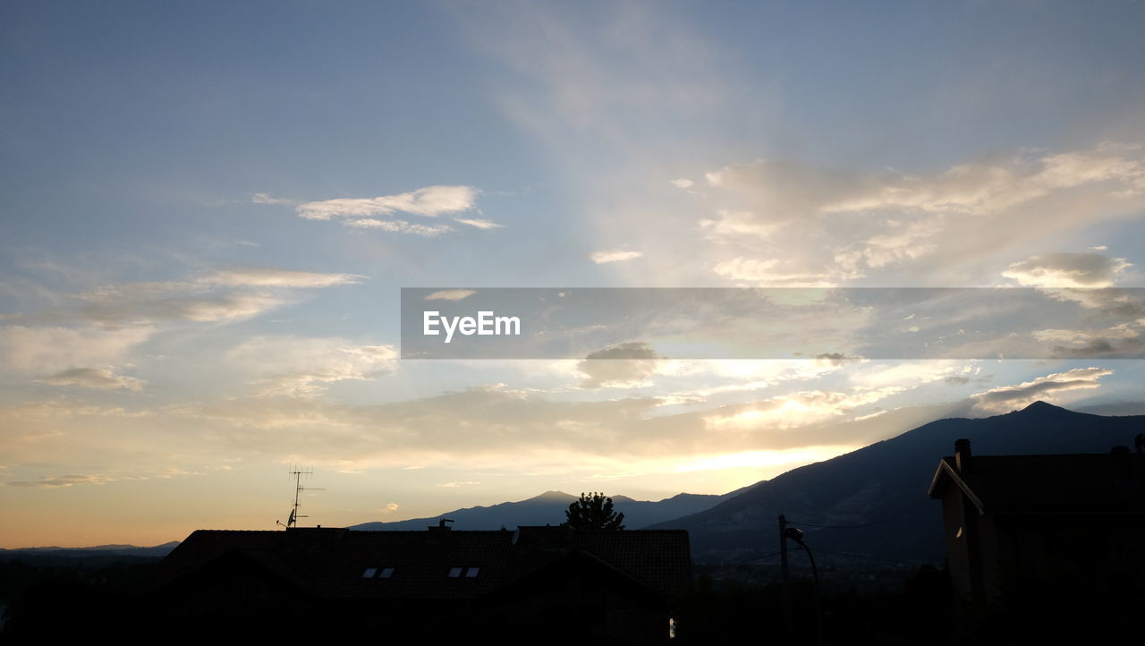 SCENIC VIEW OF MOUNTAINS AT SUNSET