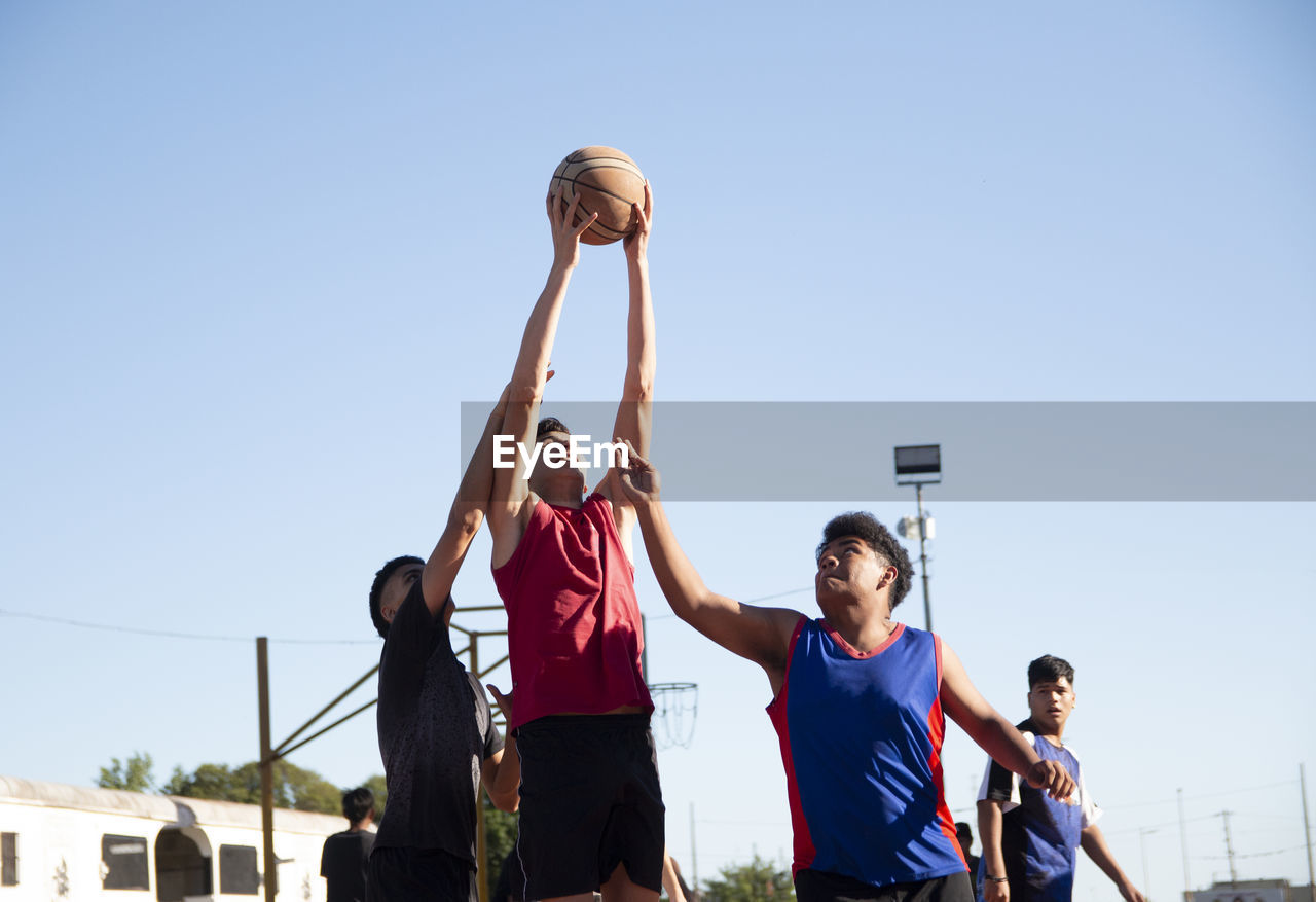 Teenagers playing basketball