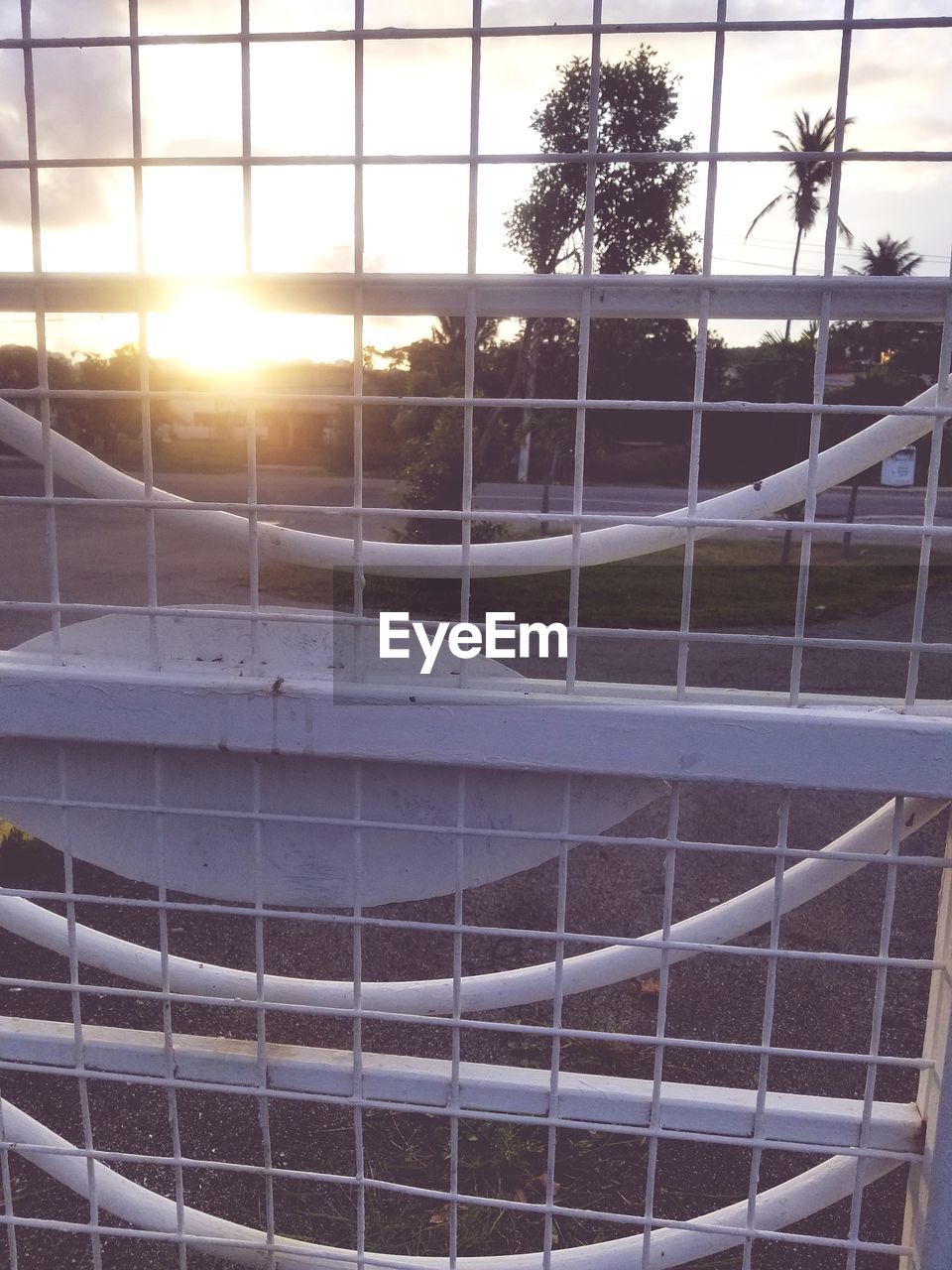 VIEW OF SWIMMING POOL AGAINST SUNSET