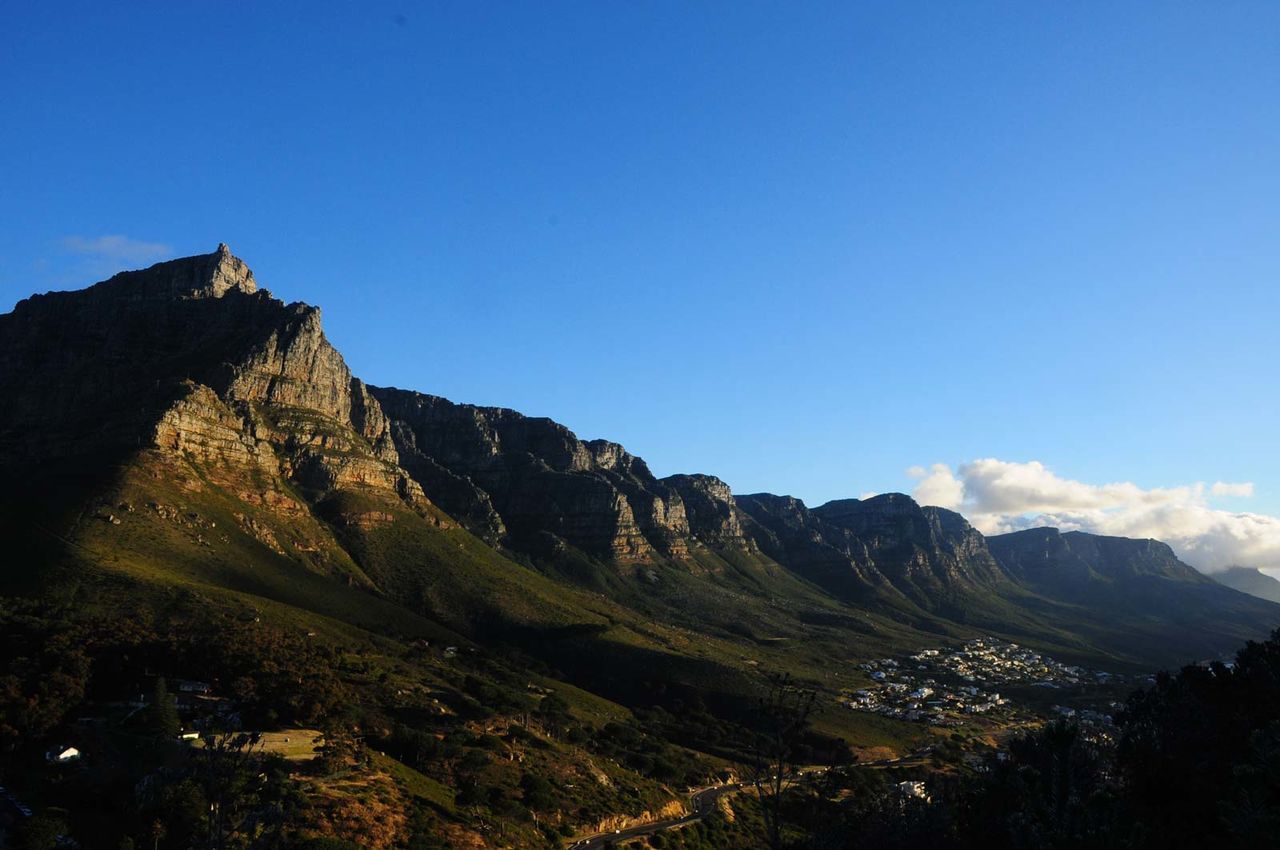 Scenic view of mountains against blue sky