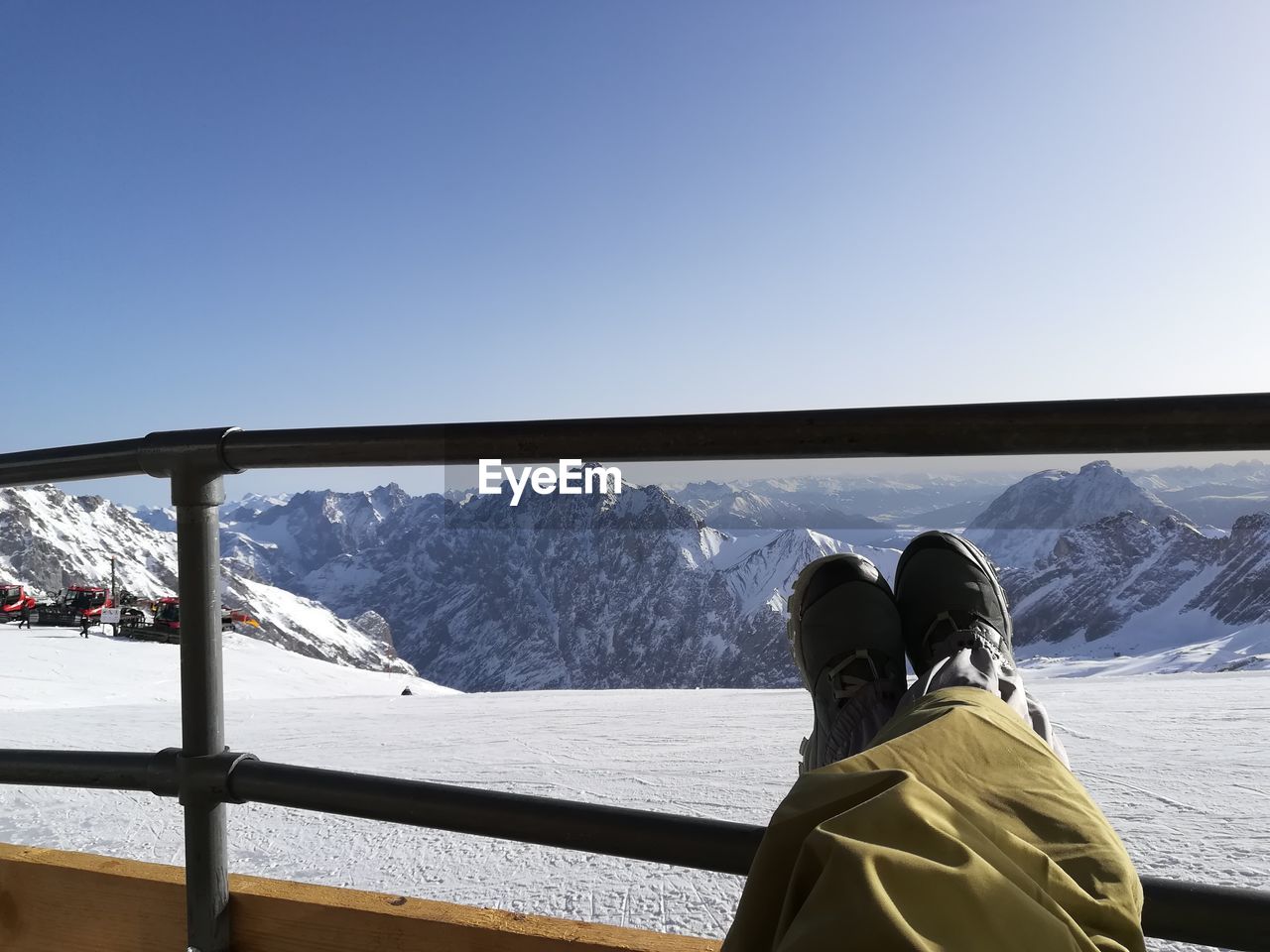 Rear view of people on snowcapped mountain against sky