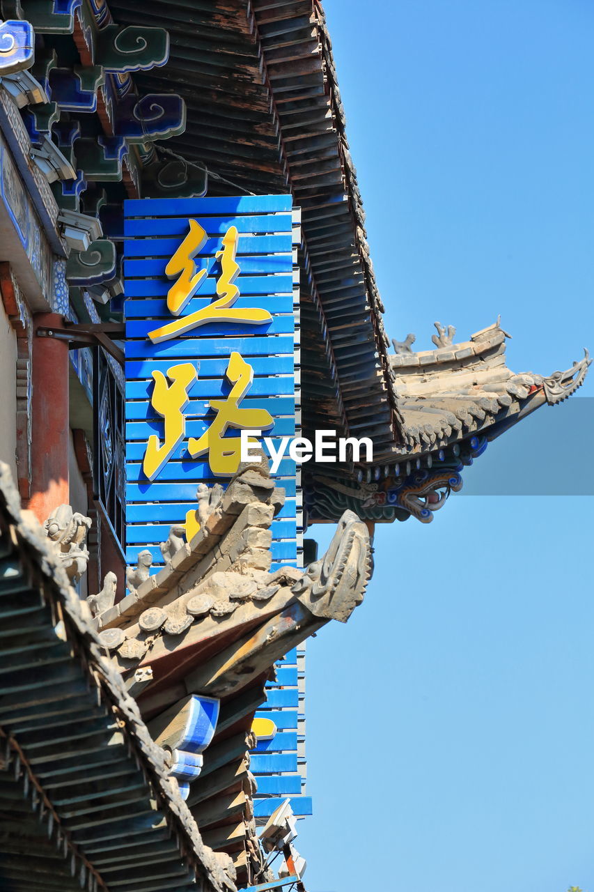 Yellow chinese writing-blue signboard-roof eaves-ming and qing dynasties food street. china-1300