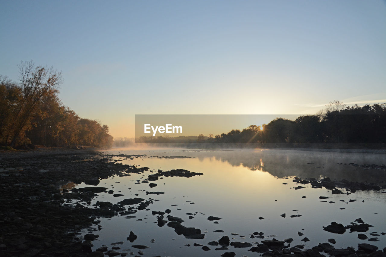 Scenic view of maumee river against clear sky during morning