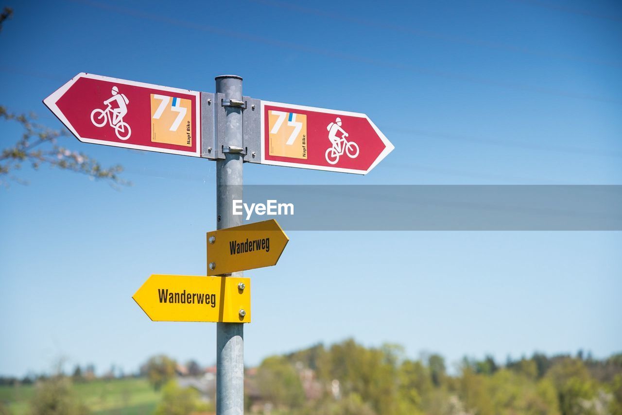 Close-up of road sign against clear sky