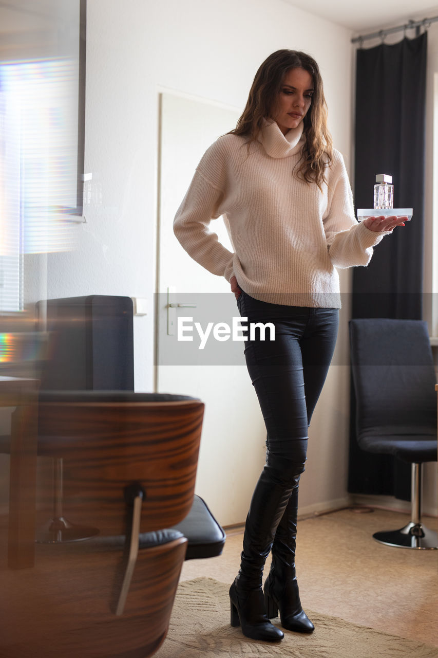 Portrait of smiling woman standing at home