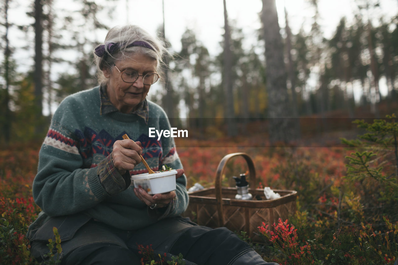 Senior woman having picnic