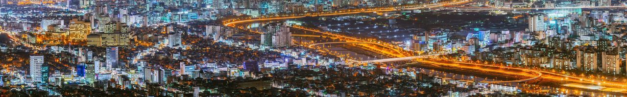 Panoramic view of illuminated cityscape at night