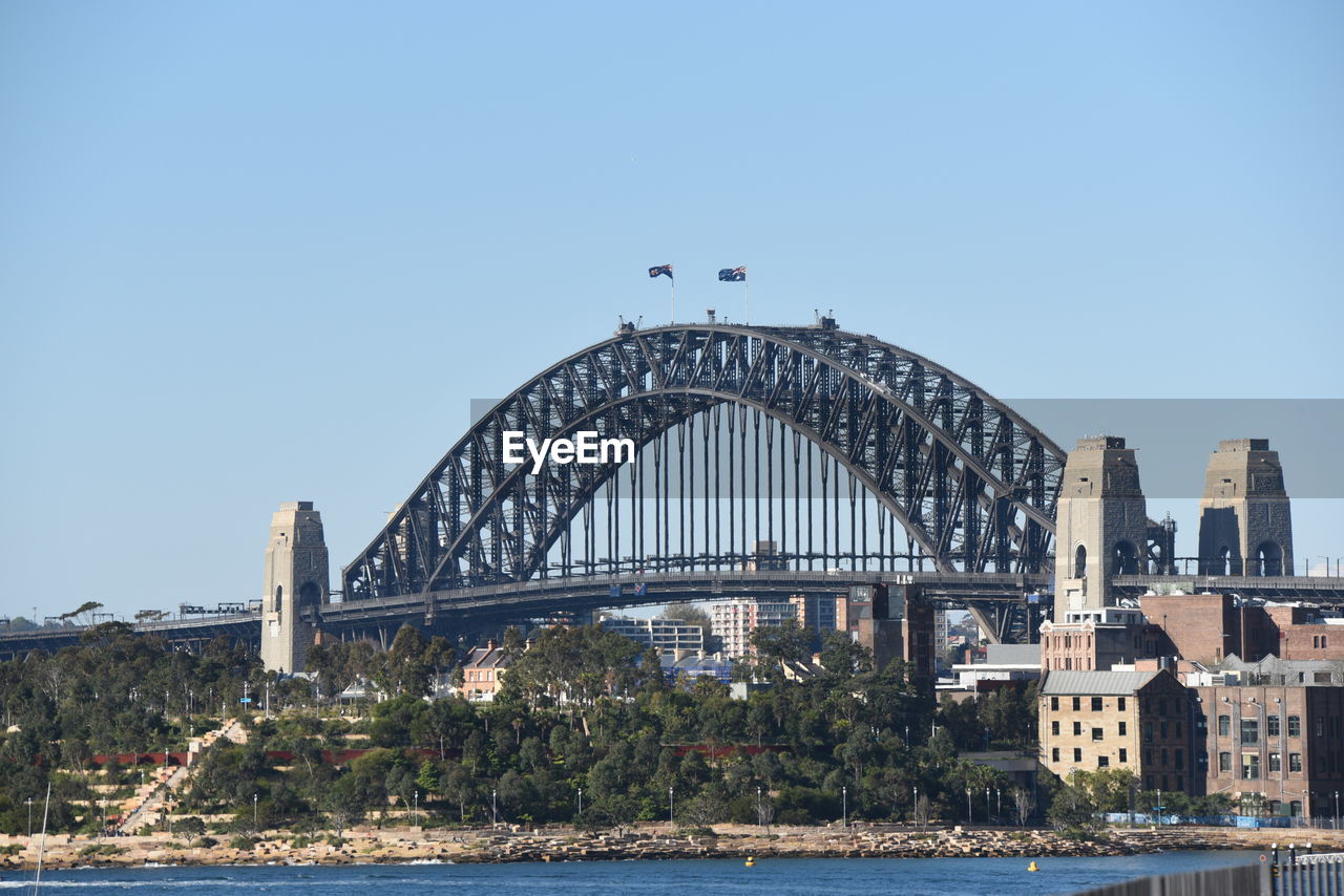 View of bridge over city against clear sky