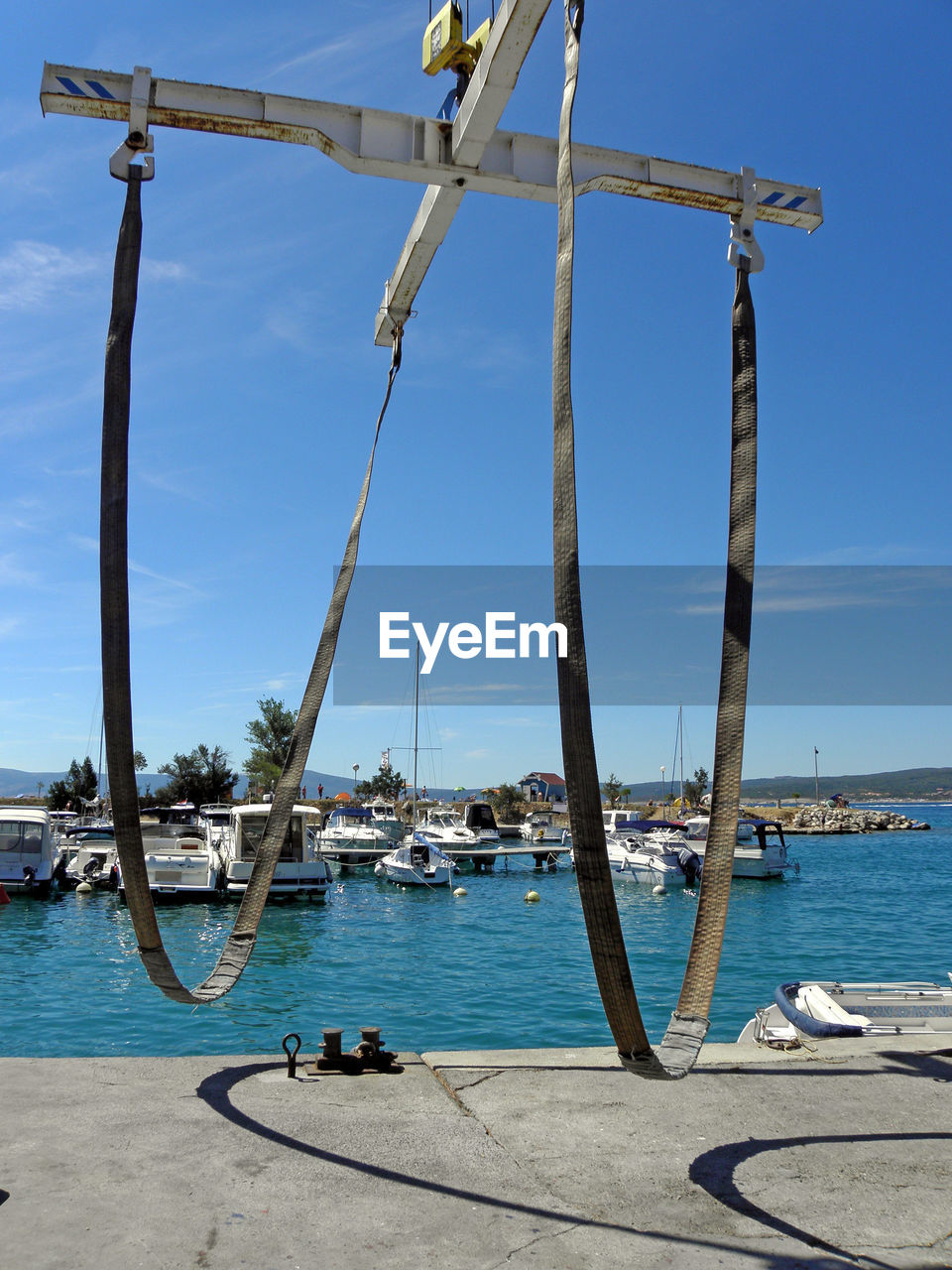 BOATS MOORED AT HARBOR AGAINST SKY