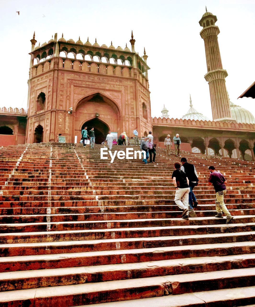 LOW ANGLE VIEW OF PEOPLE WALKING ON STEPS